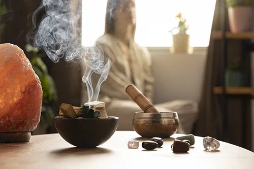 Practitioner holding hands over a client during a shamanic energy clearing session